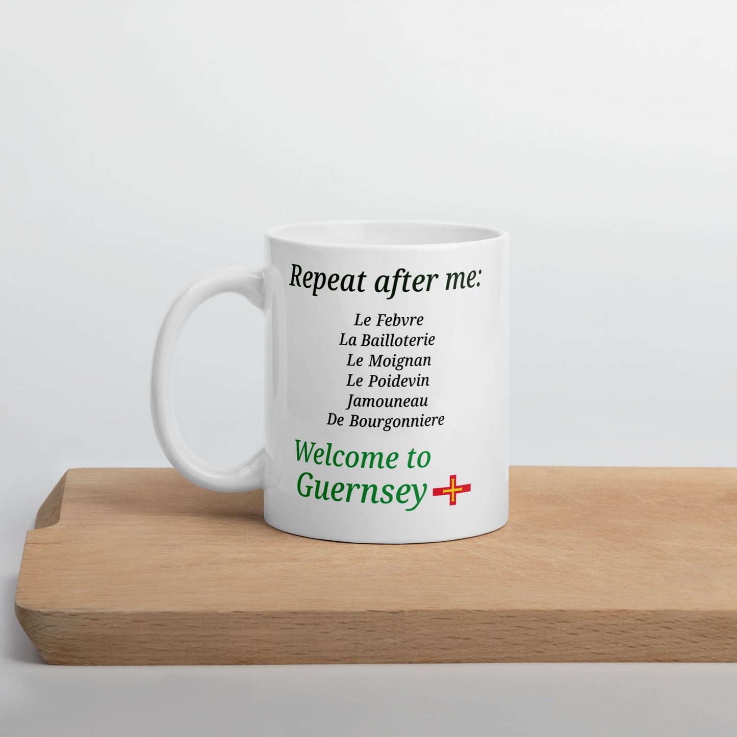White glossy mug(Repeat after me:  Le Febvre, La Bailloterie, Le Moignan, Le Poidevin, Jamouneau, De Bourgonniere - welcome to Guernsey)