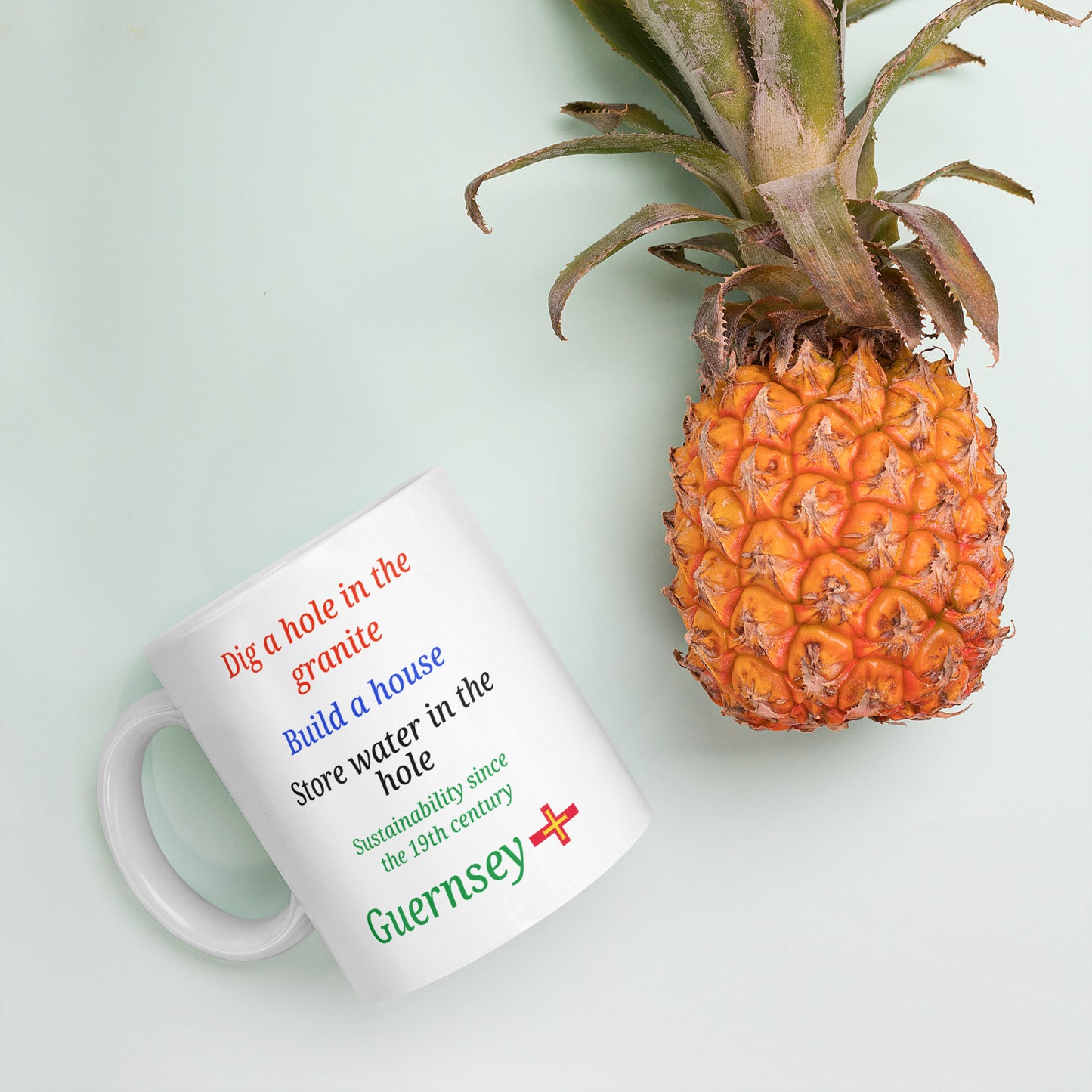 White glossy mug (Dig a hole in the granite, build a house, store water in the hole - sustainability since the 19th century)