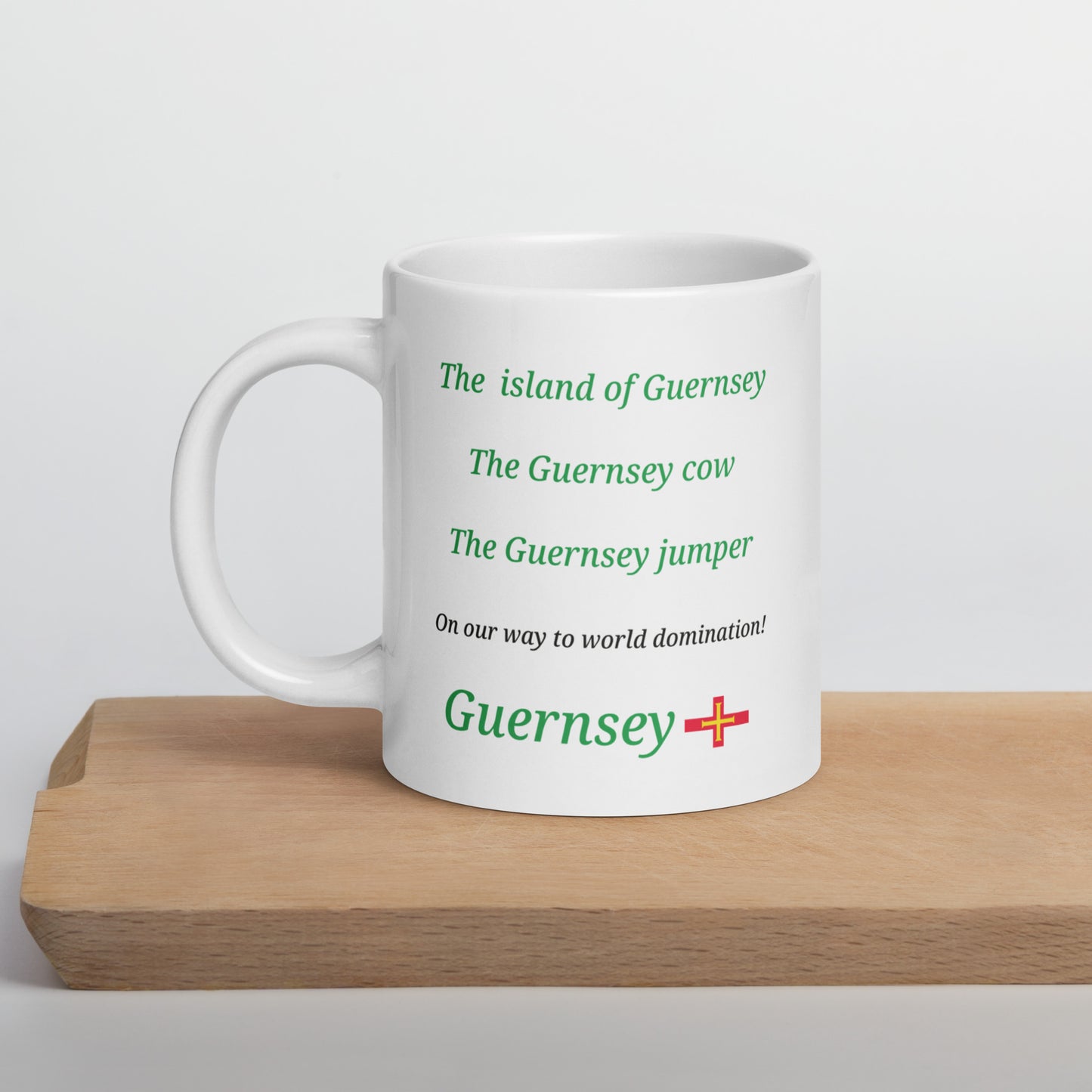 White glossy mug (The island of Guernsey, The Guernsey cow, The Guernsey jumper - on our way to World domination)